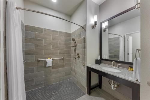 a bathroom with a sink and a shower at Best Western Plus Austin Airport Inn & Suites in Austin