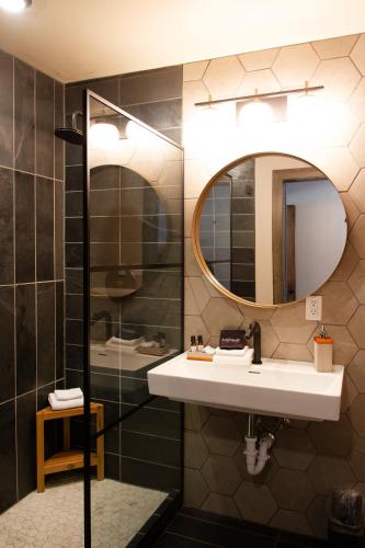 a bathroom with a sink and a mirror at Cuchara Lokal in La Veta