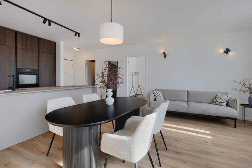 a dining room and living room with a table and chairs at Fiorea Apartment - Pula City Center With Private Garage Parking in Pula