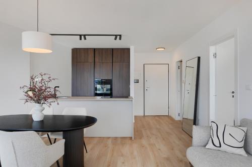 a living room with a table and a kitchen at Fiorea Apartment - Pula City Center With Private Garage Parking in Pula