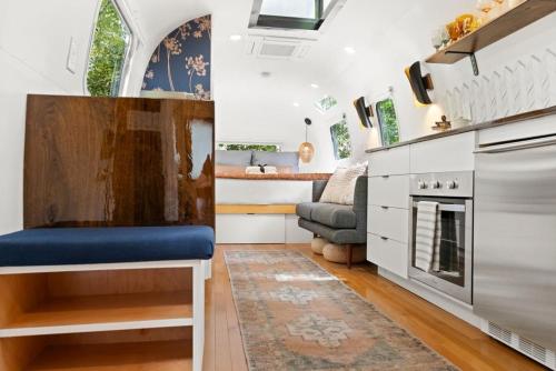 a tiny house with a kitchen and a living room at Luxury Airstream w hot tub, king bed, & grill in Pisgah Forest