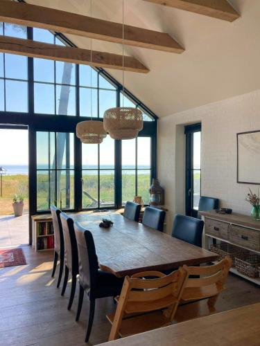 a dining room with a wooden table and chairs at Beach Villa With Private Pier In Hou in Odder