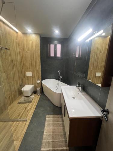 un bagno con vasca, lavandino e WC di Tasmanie B1 a Ouakam