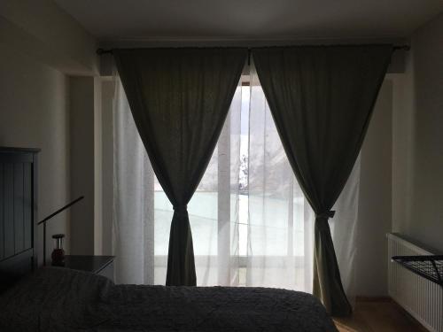 a bedroom with a bed and a large window at Apartments 315 New Gudauri 2 blok in Gudauri