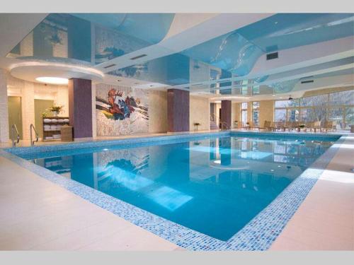 a large swimming pool in a large building at Hotel Park Ivanjica in Ivanjica