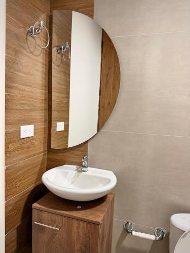 a bathroom with a sink and a mirror at Amazonía Luxury Loft 203 in Florencia