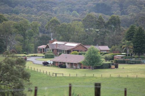 a house in the middle of a field at Langbrook Farm in Yarra Junction