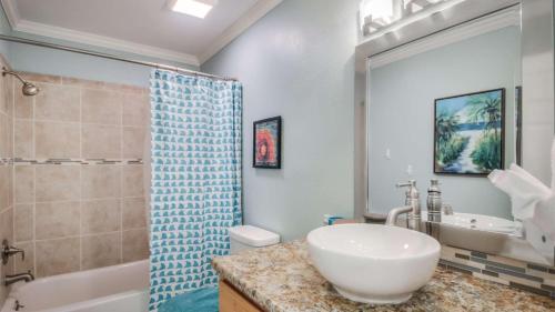 a bathroom with a sink and a toilet and a shower at Canal Place 206 in Destin