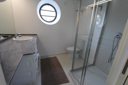 a bathroom with a shower and a sink and a toilet at OPO.APT - Art Deco Apartments in Oporto's Center in Porto