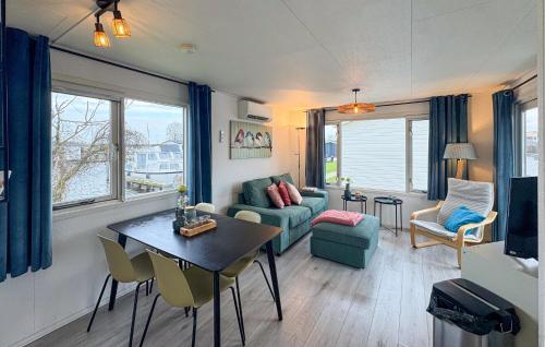 a living room with a couch and a table and chairs at Chalet in Breukelen