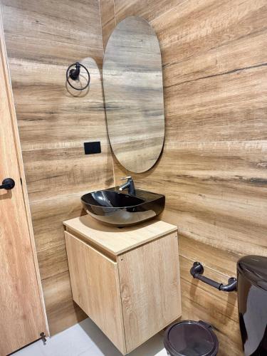 a bathroom with a sink and a mirror at Amazon Luxury Loft 201 in Florencia