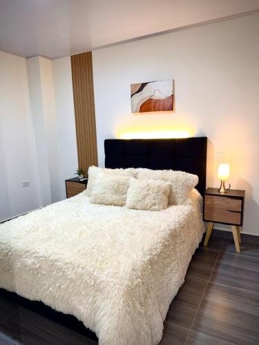 a bedroom with a large white bed with pillows at Amazon Luxury Loft 201 in Florencia
