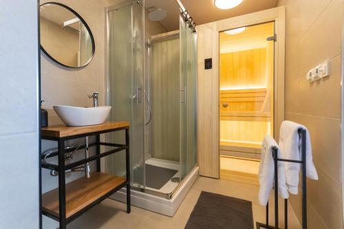 a bathroom with a sink and a shower at Timber Home in Veliko Trgovišće