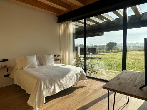 a bedroom with a bed and a large window at Casa Anjana in Rubayo