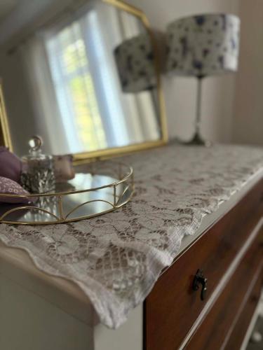 a bathroom counter with a sink and a mirror at Castle Brae Apartment in Stirling