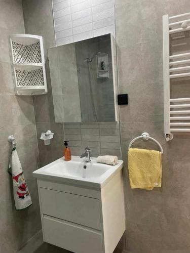 a bathroom with a sink and a mirror at Cerises in El Aouina Station