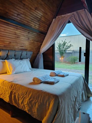 a bed with blankets and towels on top of it at 2205 Chalé Suíte Pousada CadClube in Sao Jose do Rio Preto