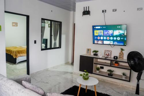 a living room with a couch and a tv on a wall at Espacio Ideal 201 in Yopal