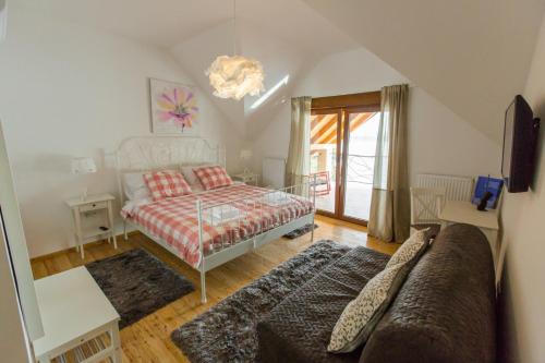 a bedroom with a bed and a couch at Jezerska Villa in Ogulin