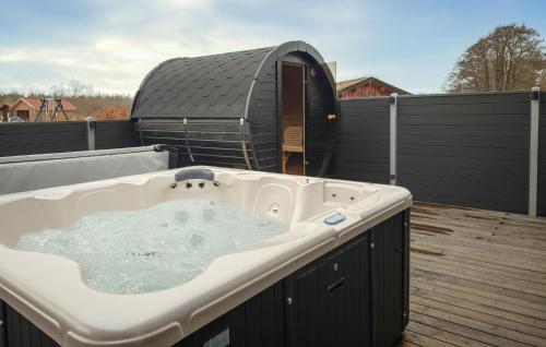 a large bath tub on a deck with a dome at Nice Home In Grenaa With Sauna in Grenå