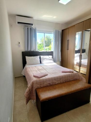 a bedroom with a large bed and a window at Apartamento com estacionamento in Uruguaiana