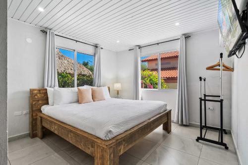 a bedroom with a large bed and a window at Salinja Cerca 2-B in Palm-Eagle Beach