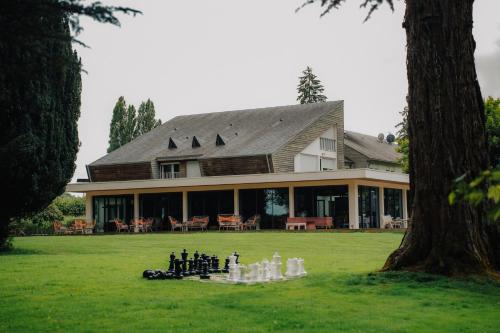 a house with a chess game in front of it at Hôtel le Corbusson Laval Ouest in Saint-Berthevin-sur-Vicoin