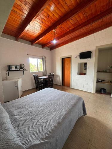 a bedroom with a bed and a table with chairs at Complejo El Teyu in Miramar