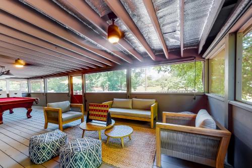 a screened in porch with furniture and a pool table at Charming Mtn View Cabin Sleeps 8 Spacious Deck in Townsend