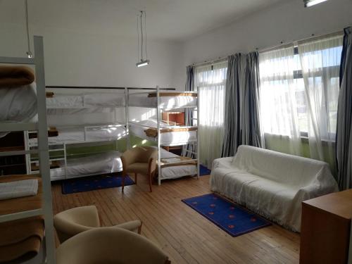 a bedroom with a bunk bed and a living room at Lagartoca in Vilar de Amargo