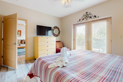 a bedroom with a bed with a dresser and a tv at Charming Condo W Shared Pools Sleeps 6 Playground in Pigeon Forge
