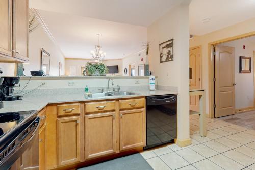 a large kitchen with a sink and a stove at Charming Condo W Shared Pools Sleeps 6 Playground in Pigeon Forge