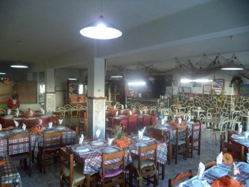 a dining room with tables and chairs in a building at Casa Romão in Nazaré