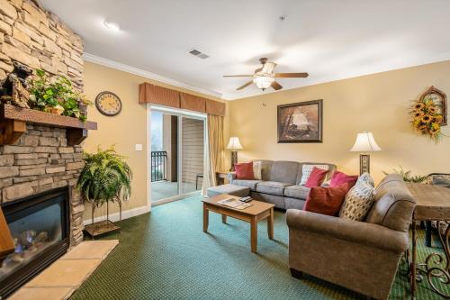 a living room with a couch and a fireplace at Downtown Summit Manor Sleeps 8 Mtn Views Pool in Gatlinburg