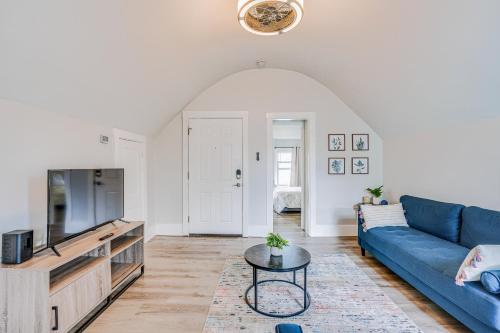 a living room with a blue couch and a tv at Weymouth Apartment Close to Beaches and Boston! in Weymouth