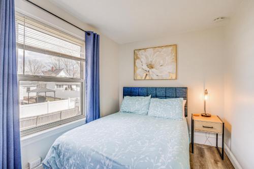 a bedroom with a blue bed and a window at Weymouth Apartment Close to Beaches and Boston! in Weymouth
