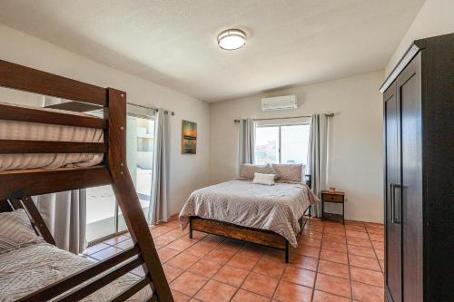 a bedroom with a bunk bed and a bed at Casa Sonora in Puerto Peñasco