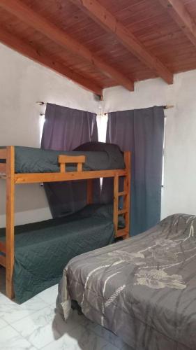 a bedroom with two bunk beds in a room at El encanto in Santa María