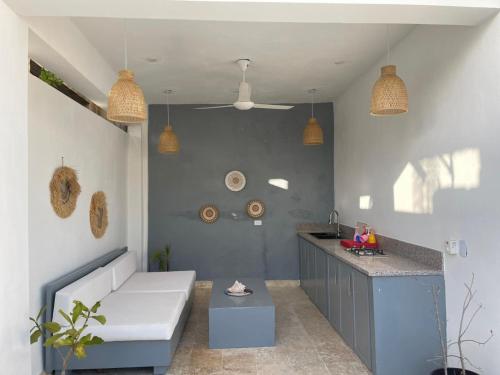 a kitchen with a white couch and a counter at Villa Dylan Samana, Luxury 3Br with pool in Santa Bárbara de Samaná