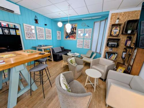 a room with blue walls and chairs and a table at greet Grenoble Centre Gare Accor Hotel in Grenoble