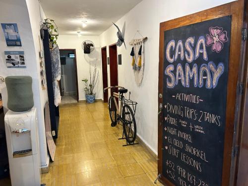 a room with a chalkboard with a bike on the wall at Casa Samay in Cozumel