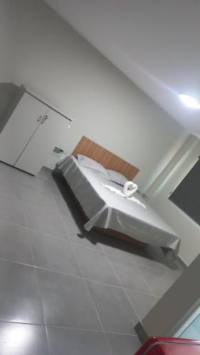 a bathroom with a bed in a room at Litoral suítes in Araruama