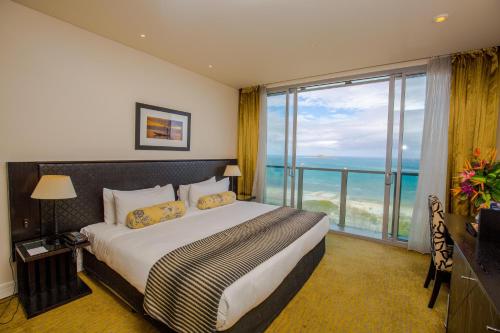a hotel room with a bed and a large window at Grand Papua Hotel in Port Moresby