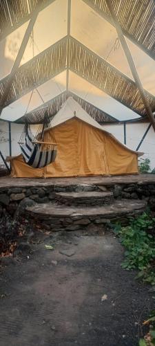 a tent with a hammock hanging from the ceiling at El Pital, Chocolate Paradise in Balgue