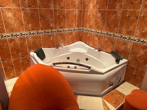 a bath tub in a bathroom with a sink at Restoran Gurman in Kraljevo