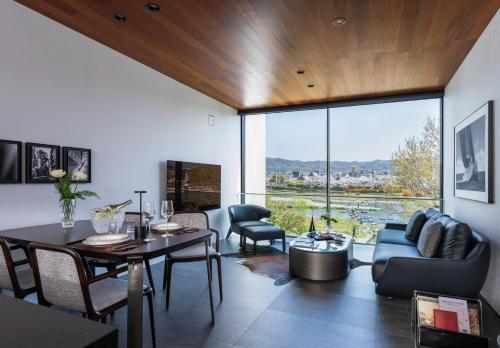 a living room with a table and a couch at Kamo Residences by Reflections in Kyoto