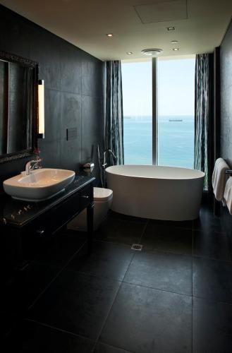 a large bathroom with a tub and a sink at Grand Papua Hotel in Port Moresby