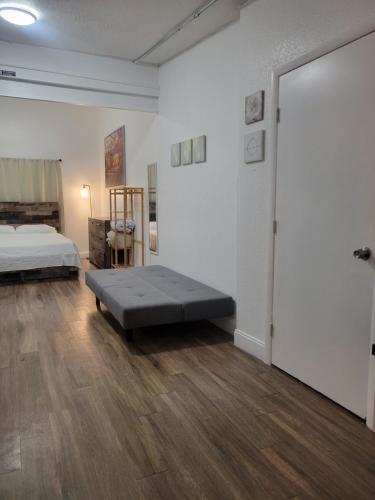a large room with a bed and a large door at Charming Private Studio,Full Amenities, Great Location in Orlando