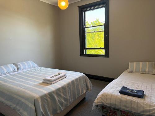 a bedroom with two beds and a window at Golden Age Hotel in Beaufort