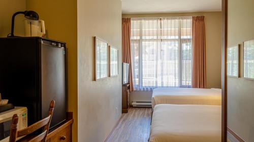 a hotel room with two beds and a window at Cahilty #120 home in Sun Peaks